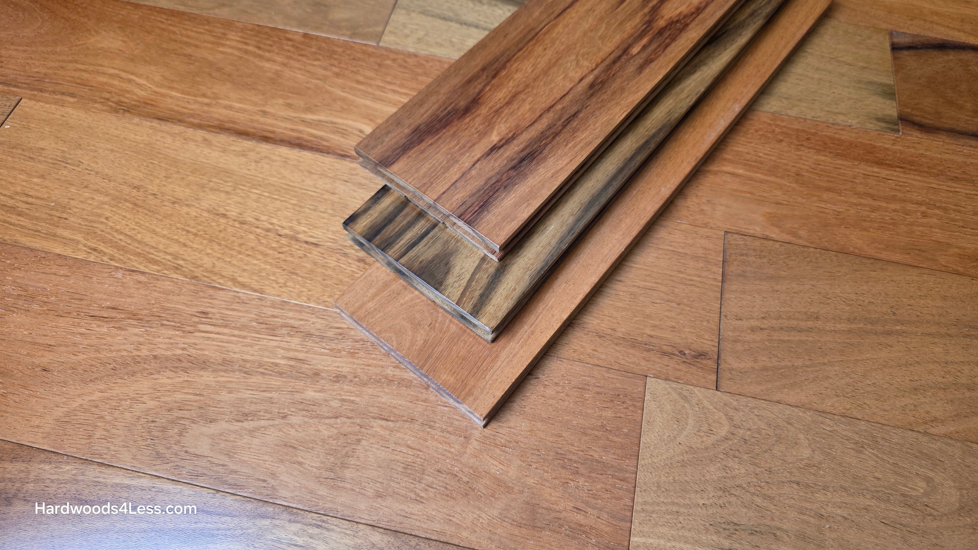 5" x 3/4" Prefinished Brazilian Cherry Shorts Hardwood Flooring. Shown as 3 boards stacked on top of the Brazilian cherry floor. 