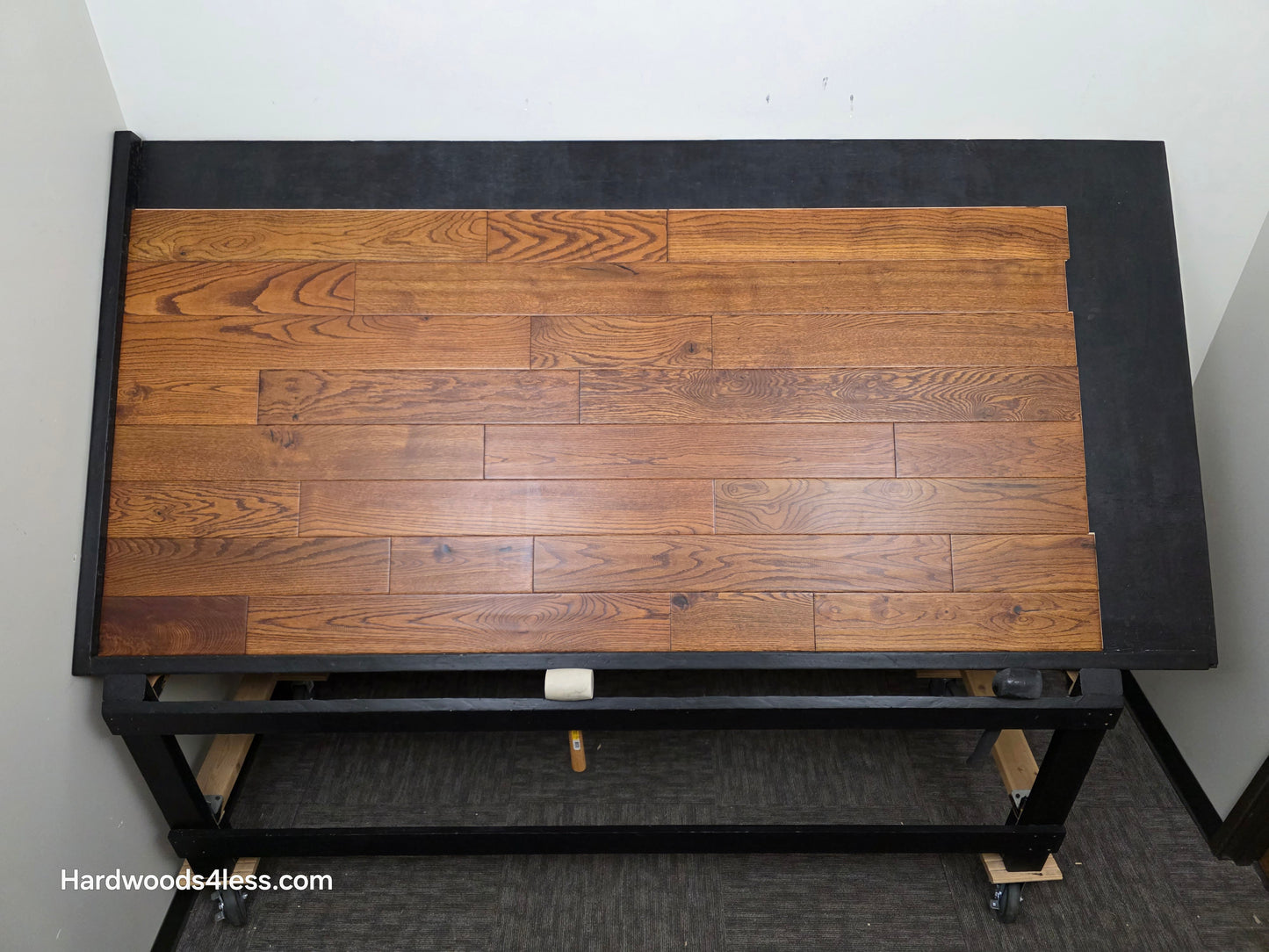 5" x 3/4" Solid Red Oak Affogato Hardwood Flooring. Shown on a black shooting table. Shot from center.