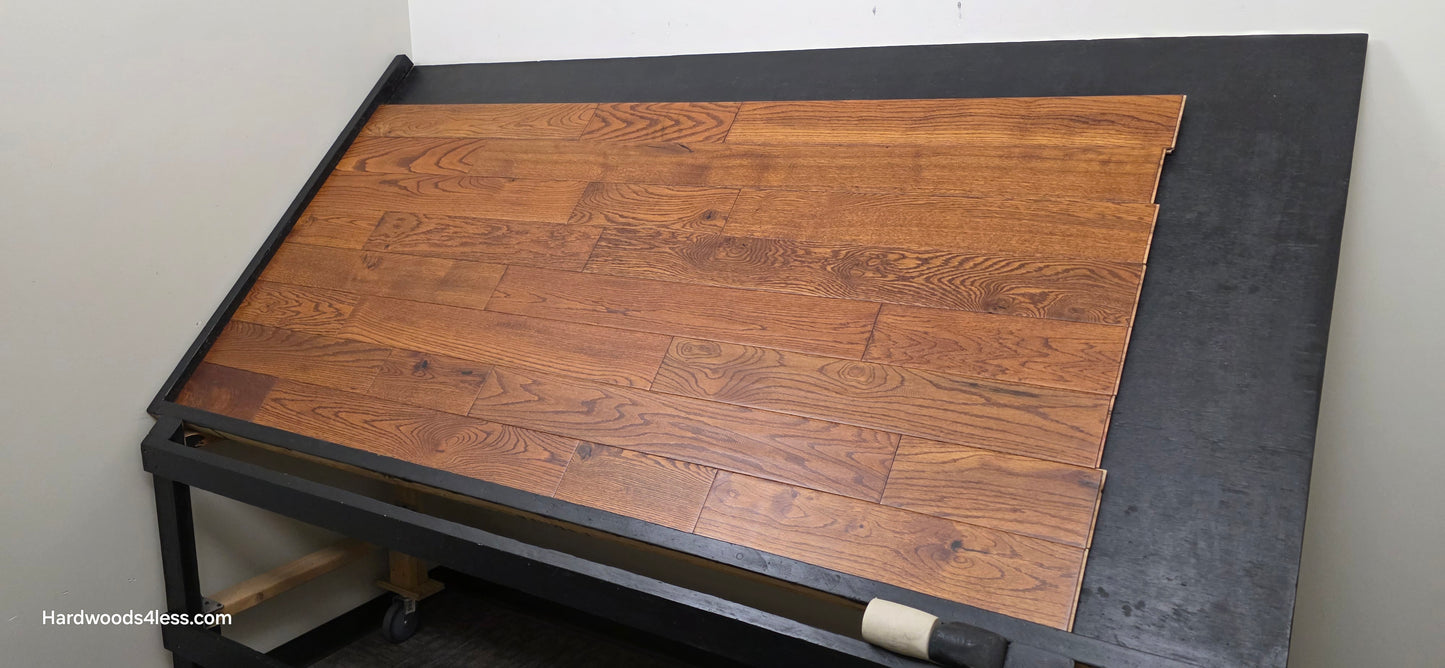 5" x 3/4" Solid Red Oak Affogato Hardwood Flooring. Shown on a black shooting table. Shot from wide right.