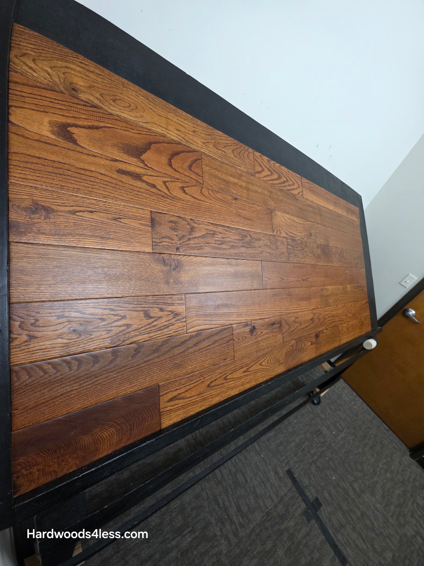 5" x 3/4" Solid Red Oak Affogato Hardwood Flooring. Shown on a black shooting table. Shot from steep left. 