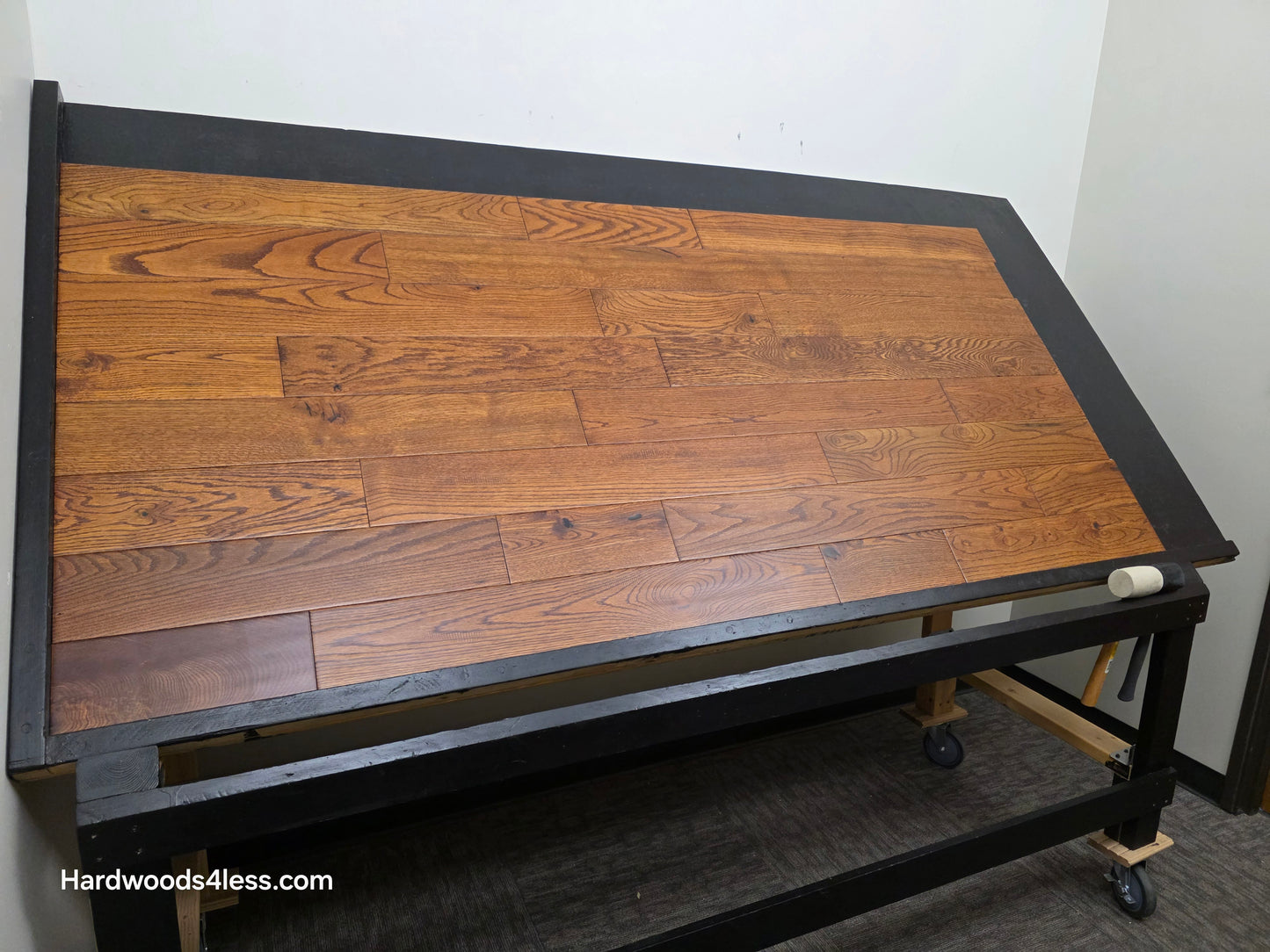 5" x 3/4" Solid Red Oak Affogato Hardwood Flooring. Shown on a black shooting table. Shot from wide left.