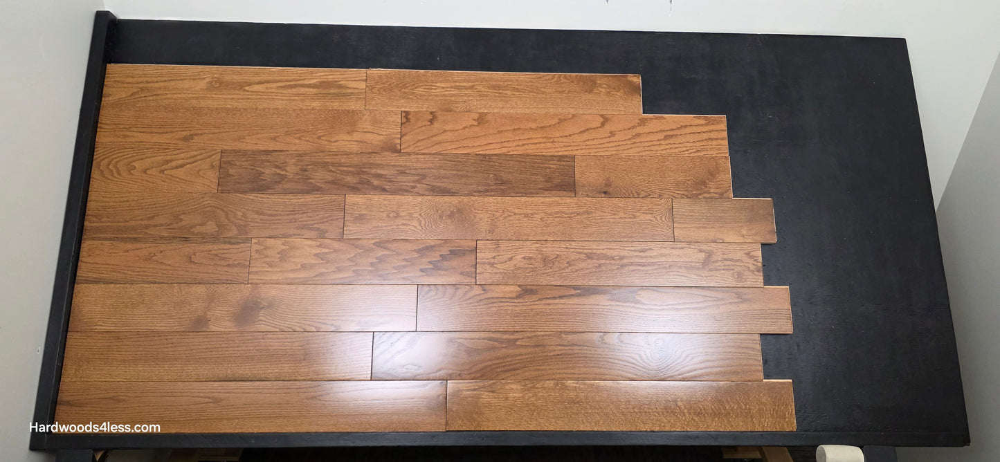 5 x 34 Solid Red Oak Hide Hardwood Flooring. Shown on a black shooting table. Shot from center.