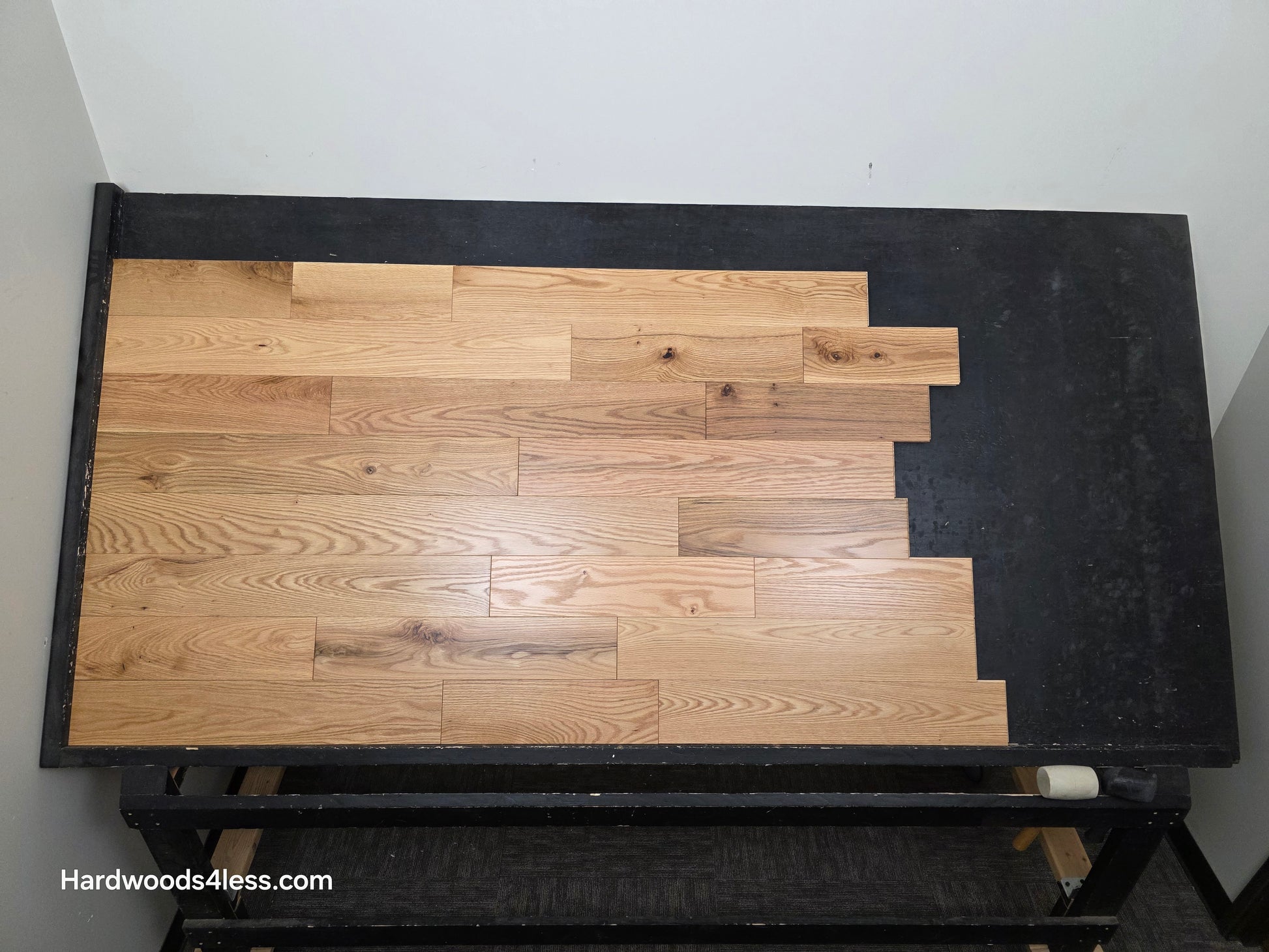 5" x 3/4" Solid Red Oak Low Gloss Common & Better Hardwood Flooring Shown on a black shooting table. Shot from center.