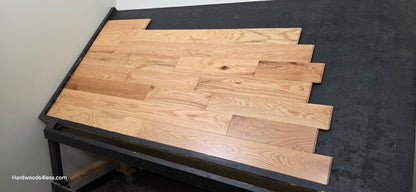 5" x 3/4" Solid Red Oak Natural Mill Run Hardwood Flooring. Shown on a black shooting table. Right hand shot. 