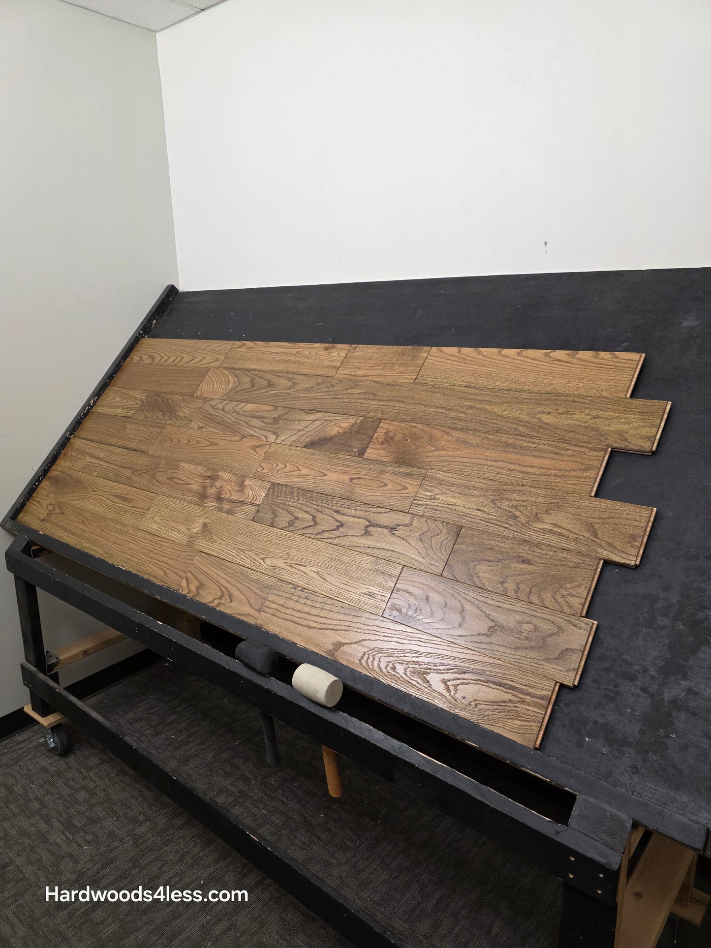 Solid Red Oak Purslane Hardwood Flooring shown on a black shooting rack from far away right