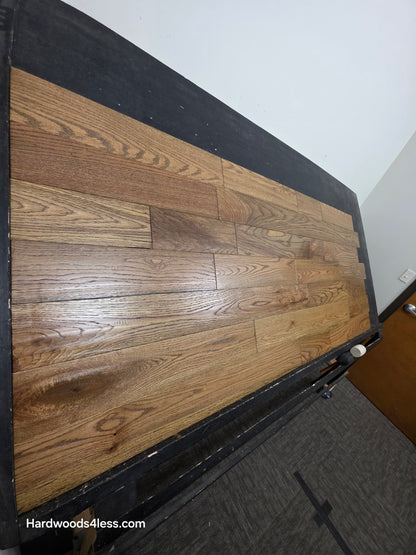 Solid Red Oak Purslane Hardwood Flooring shown on a black shooting rack shot from steep left