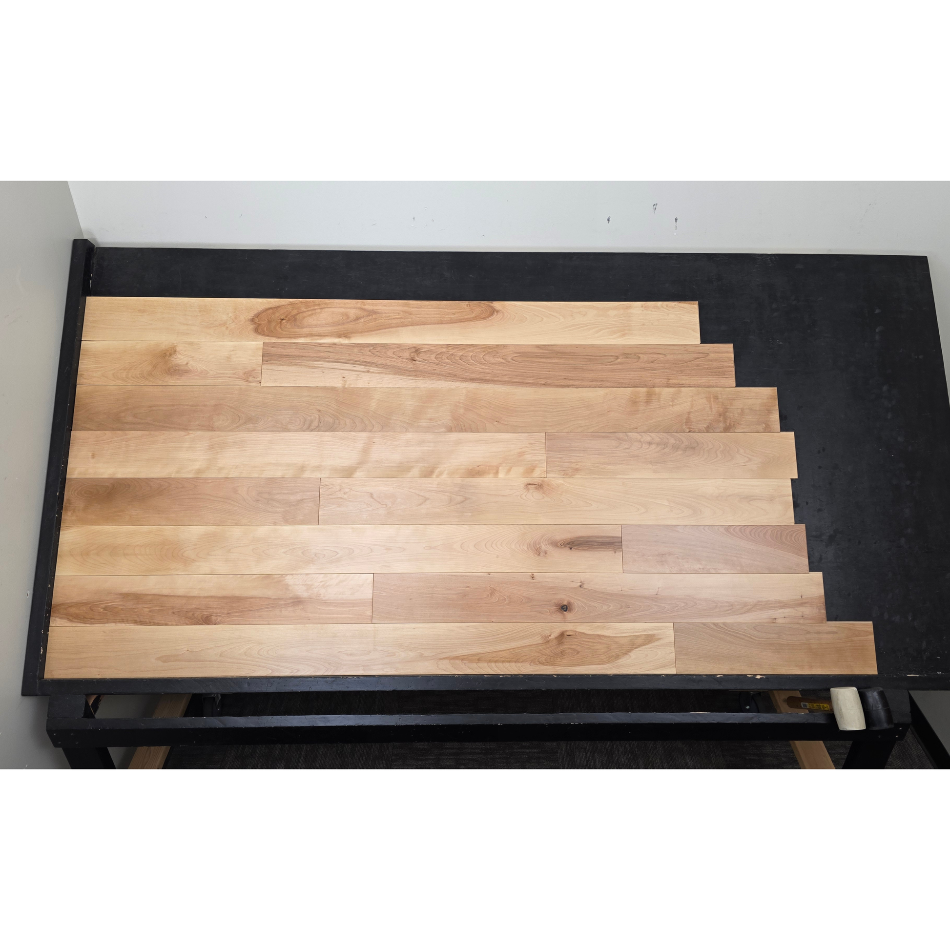 5" x 3/4" Solid Yellow Birch Natural Hardwood Flooring shown on a black shooting table. Shot from center. 