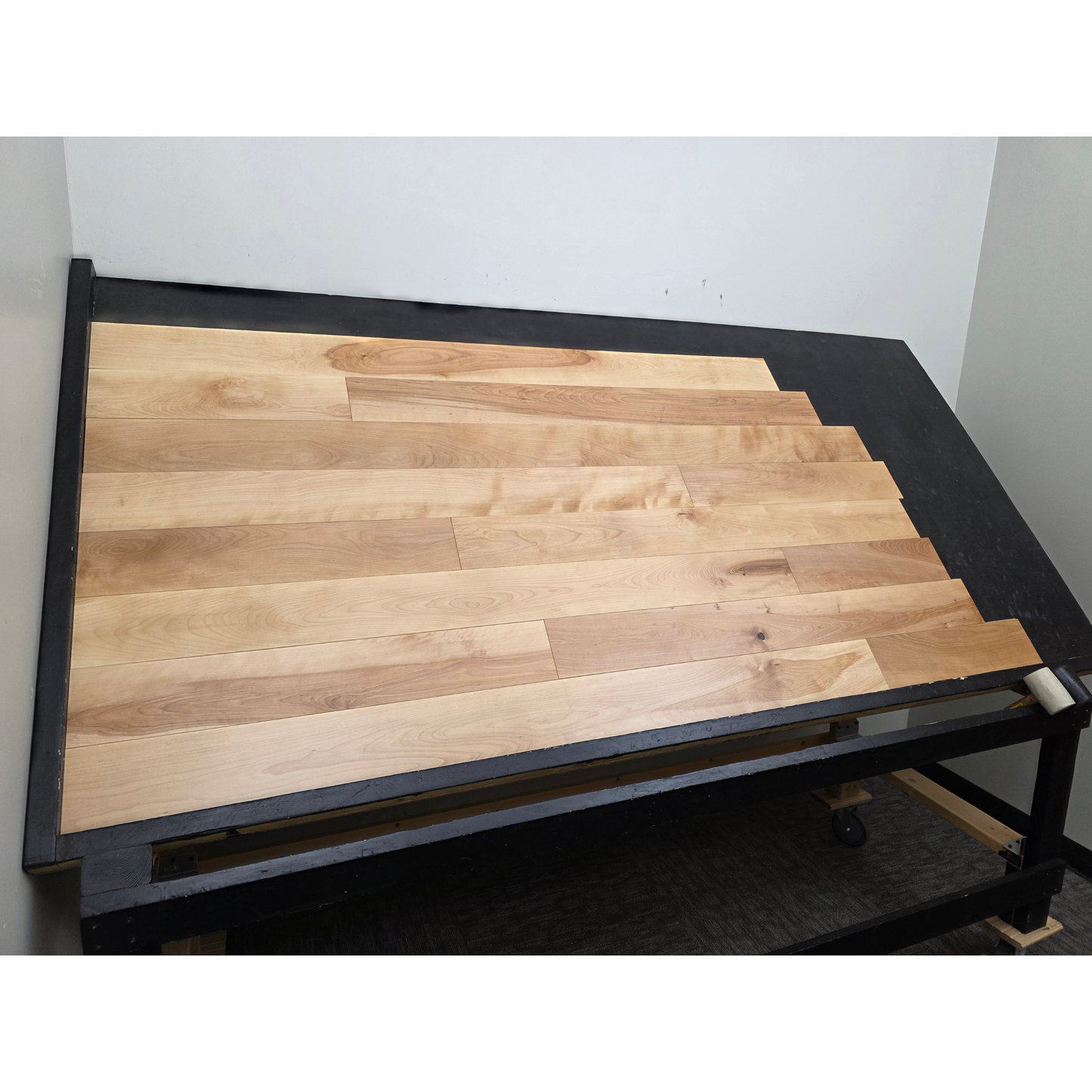 5" x 3/4" Solid Yellow Birch Natural Hardwood Flooring shown on a black shooting table. Shot from wide left.