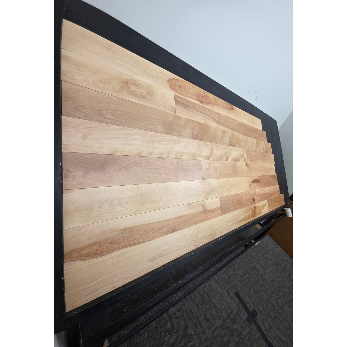 5" x 3/4" Solid Yellow Birch Natural Hardwood Flooring shown on a black shooting table. Shot from steep left. 