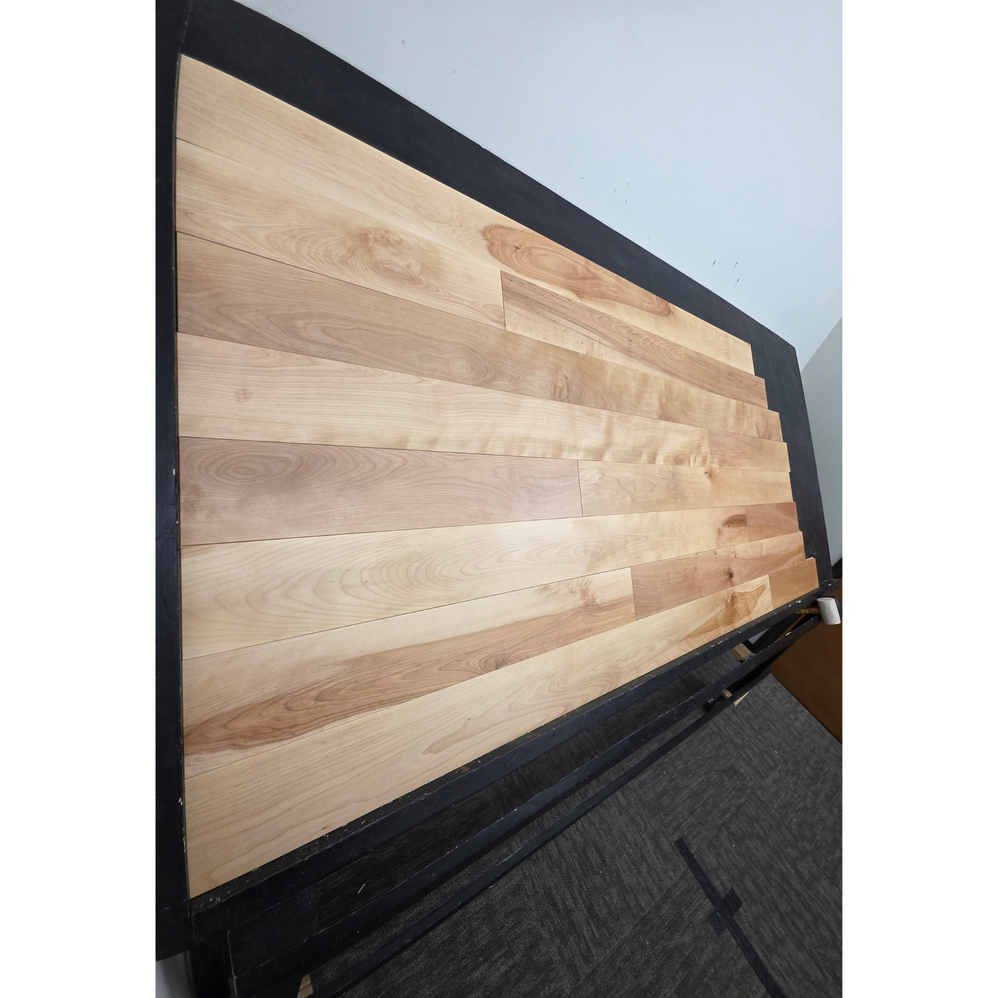 5" x 3/4" Solid Yellow Birch Natural Hardwood Flooring shown on a black shooting table. Shot from steep left. 