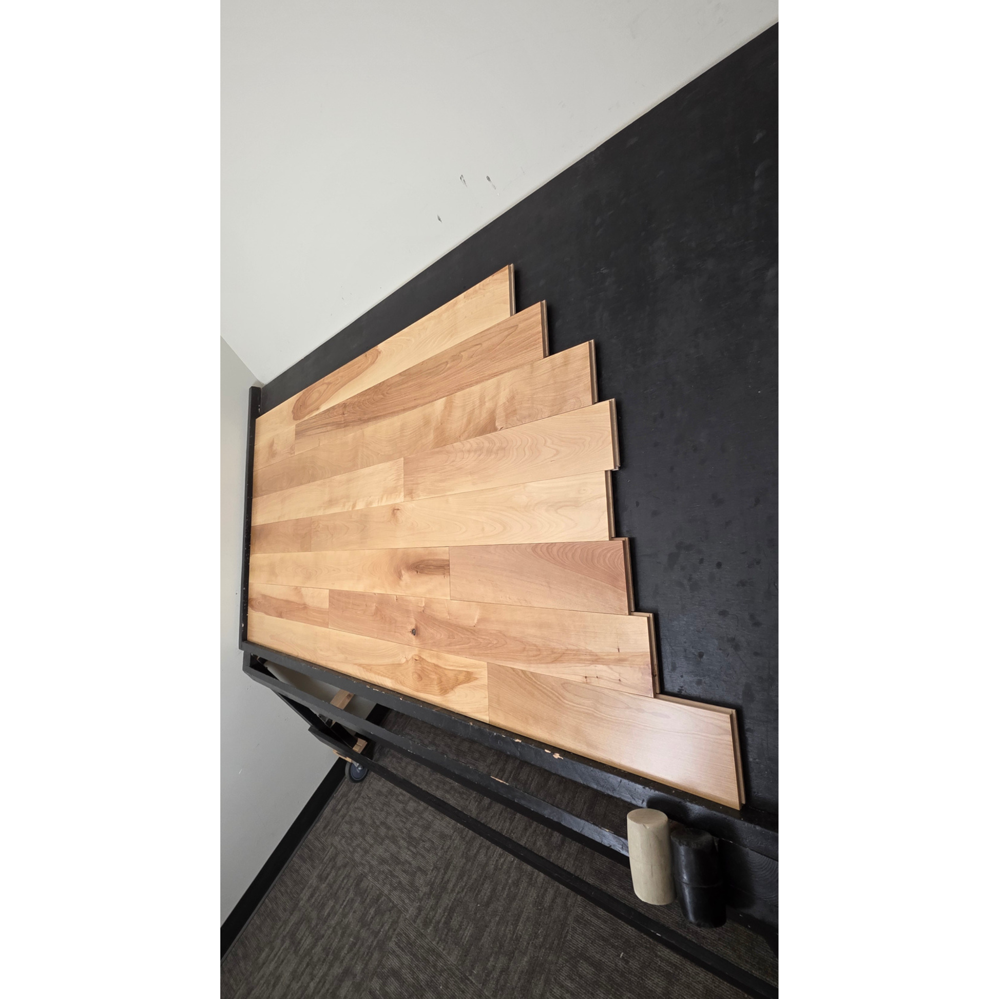 5" x 3/4" Solid Yellow Birch Natural Hardwood Flooring shown on a black shooting table. Shot from steep right.