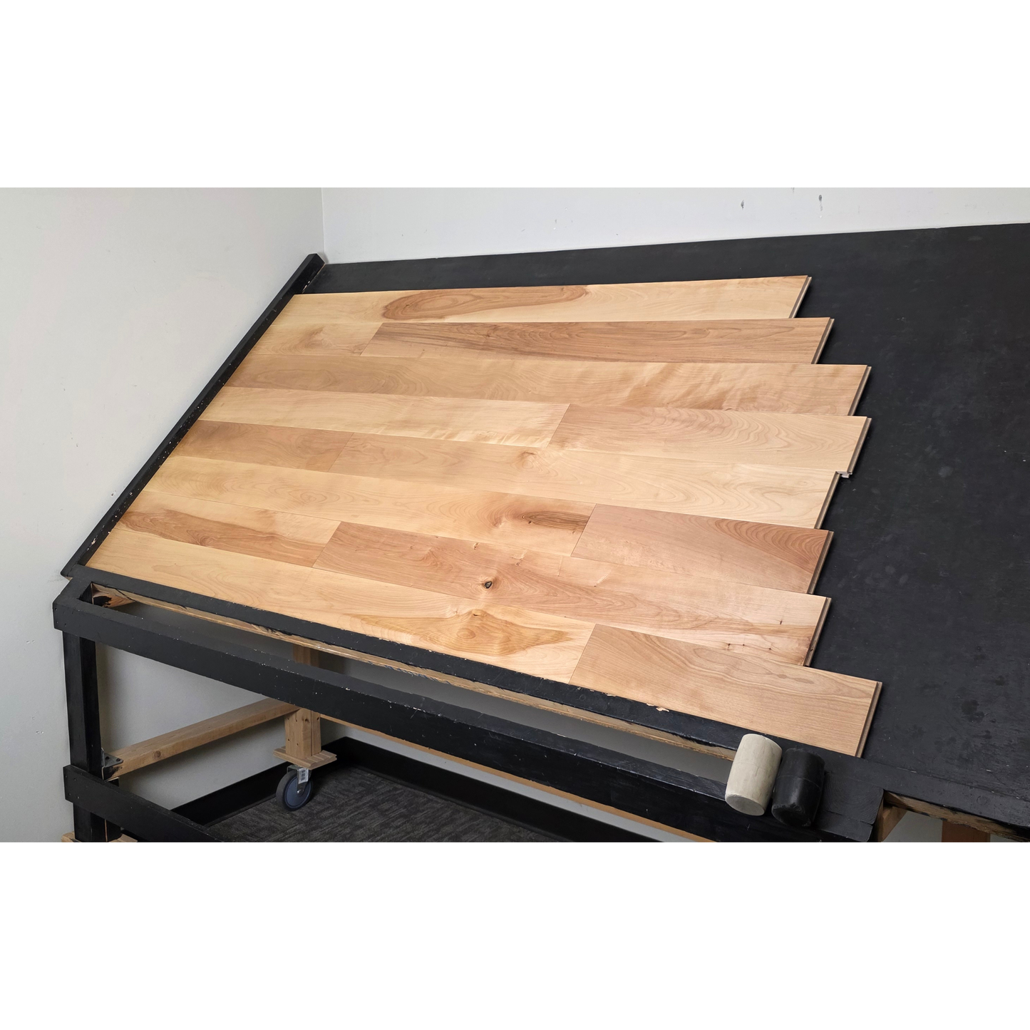5" x 3/4" Solid Yellow Birch Natural Hardwood Flooring shown on a black shooting table. Shot from wide right.