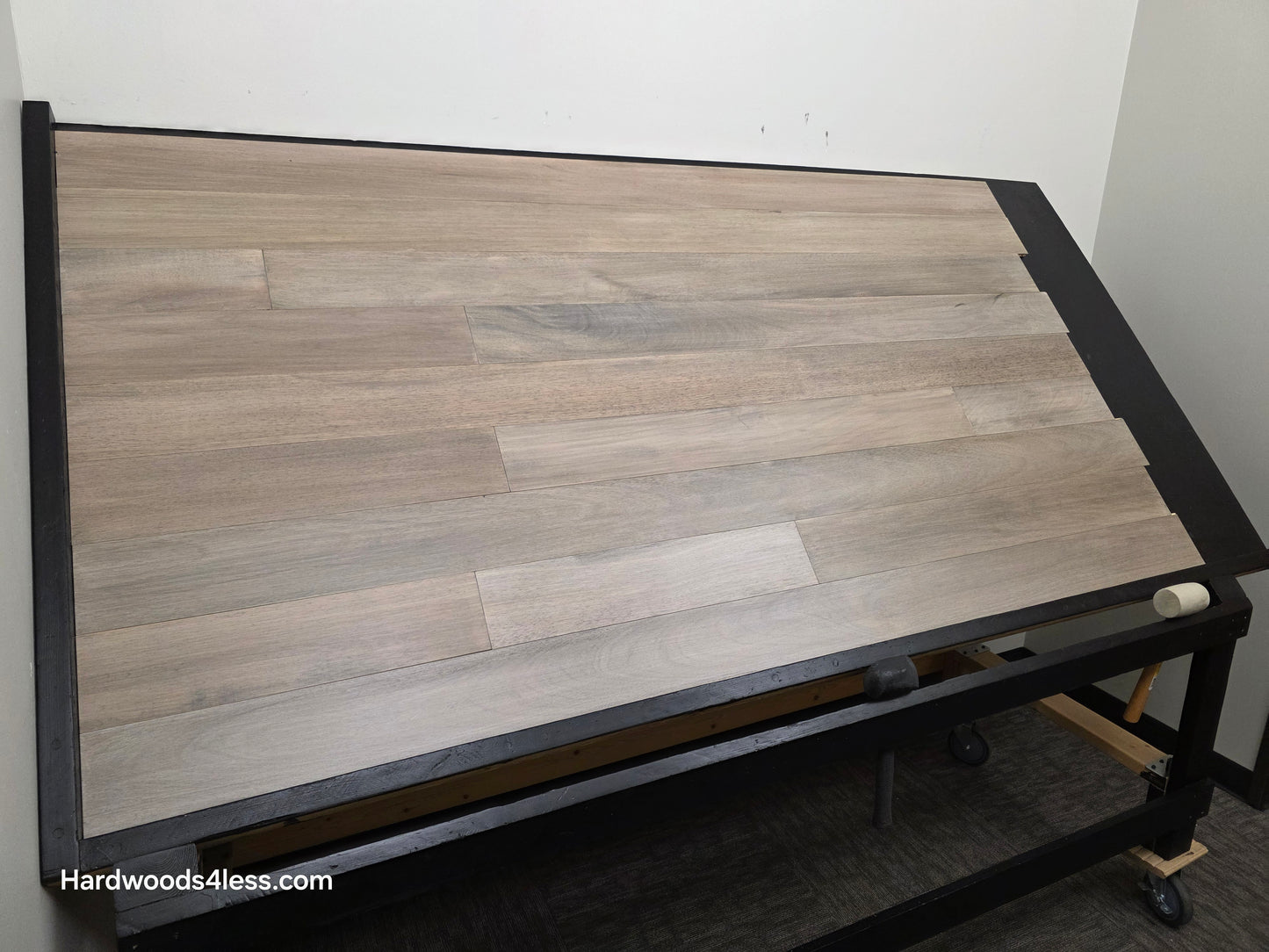 5" x 9/16" Engineered Brazilian Oak Light Grey Hardwood Flooring. Shown on a black shooting table. Shot from wide left.