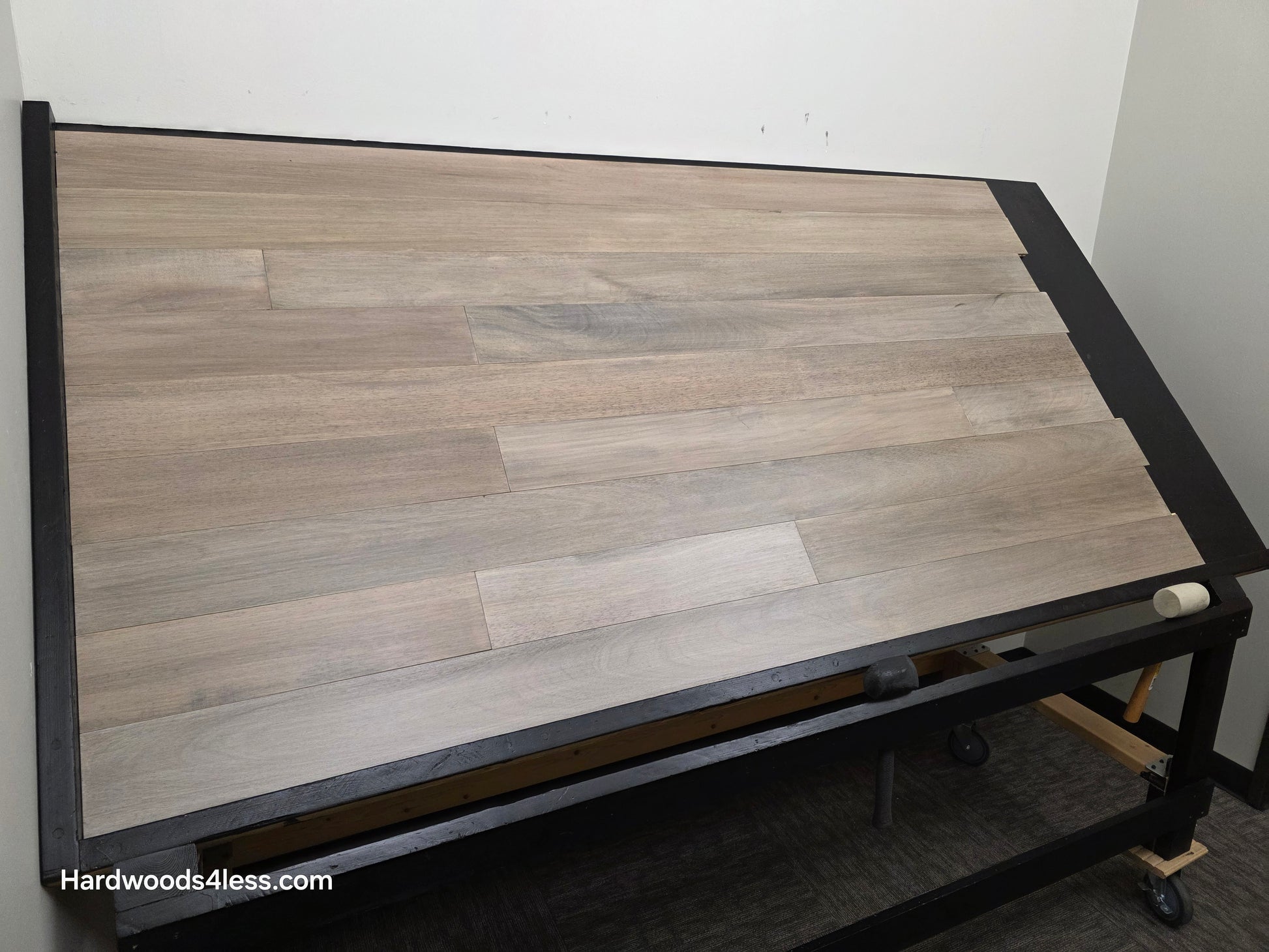 5" x 9/16" Engineered Brazilian Oak Light Grey Hardwood Flooring. Shown on a black shooting table. Shot from wide left.