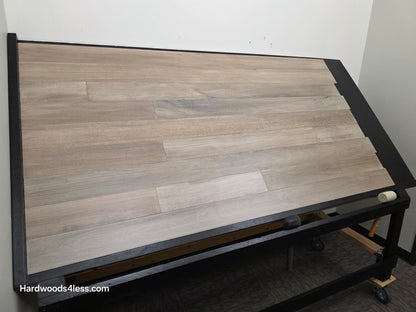 5" x 9/16" Engineered Brazilian Oak Light Grey Hardwood Flooring. Shown on a black shooting table. Shot from wide left.