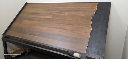 5" x 9/16" Engineered Brazilian Oak Pebble Hardwood Flooring. Shown on a black shooting table. shot from wide right.