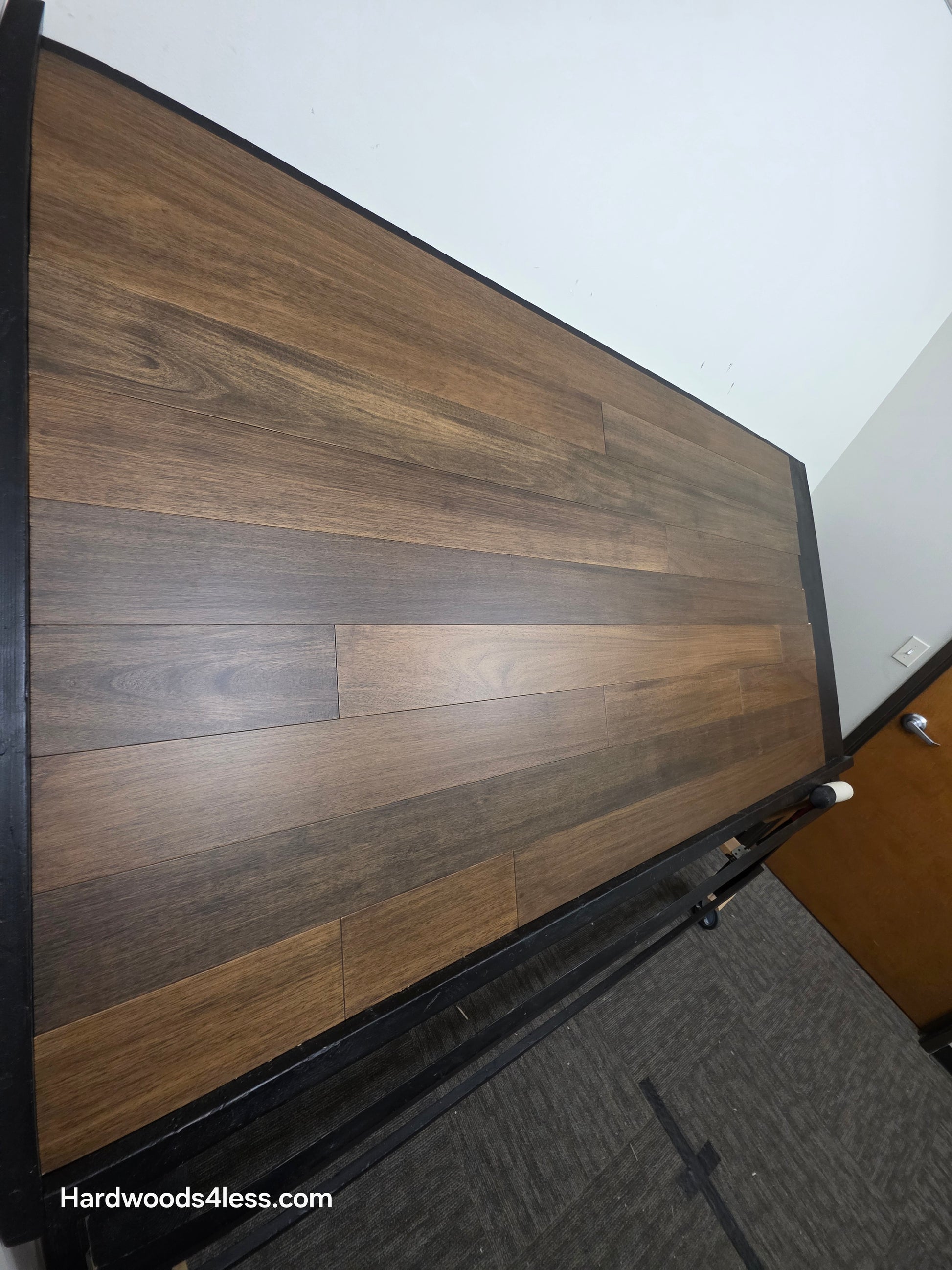 5" x 9/16" Engineered Brazilian Oak Pebble Hardwood Flooring. Shown on a black shooting table. shot from steep left.