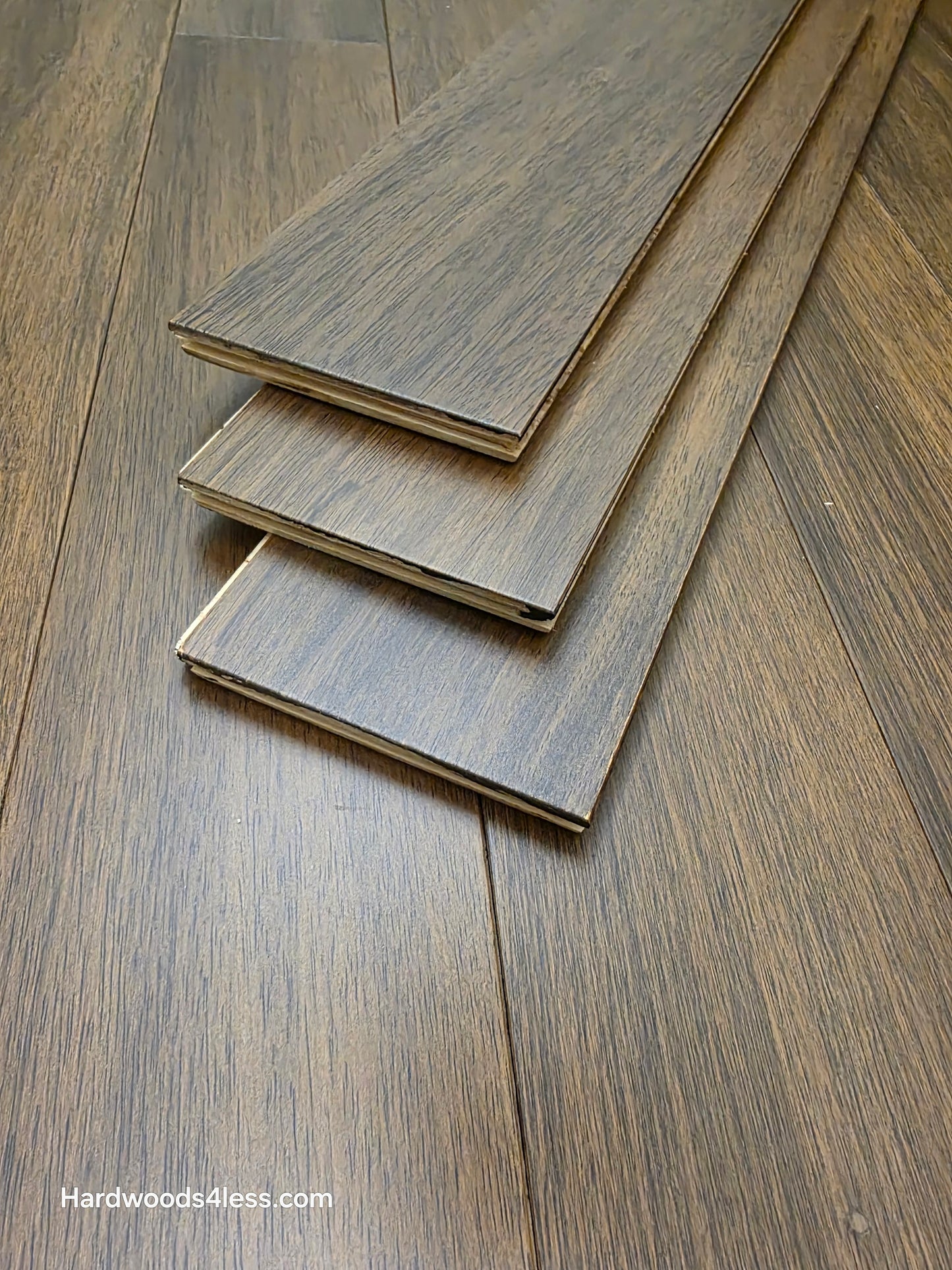 7" x 9/16" Engineered Brazilian Oak Pebble Hardwood Flooring. Close up of 3 boards on the floor.