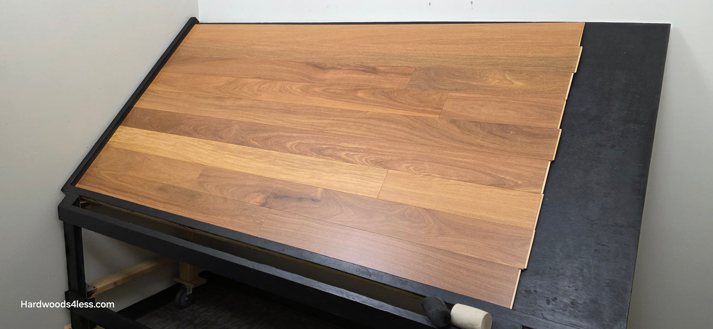 5" x 9/16" Engineered Brazilian Teak Hardwood Flooring. Shown on a black shooting table. Shot from wide right. 