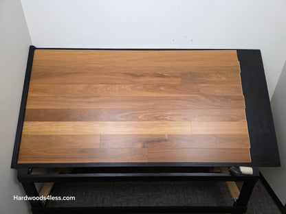 5" x 9/16" Engineered Brazilian Teak Hardwood Flooring. Shown on a black shooting table. Shot from Center.