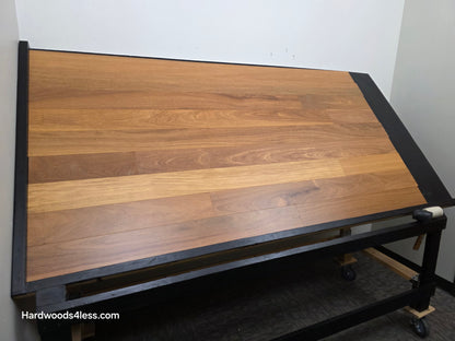 5" x 9/16" Engineered Brazilian Teak Hardwood Flooring. Shown on a black shooting table. Shot from wide left.