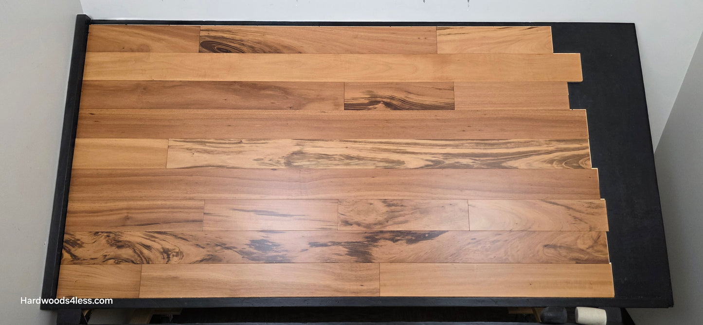 5" x 9/16" Engineered Brazilian Tigerwood Natural Hardwood Flooring. Shown on a black shooting table. Shot from center.