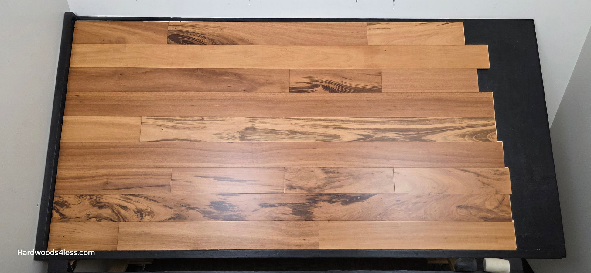 5" x 9/16" Engineered Brazilian Tigerwood Natural Hardwood Flooring. Shown on a black shooting table. Shot from center.