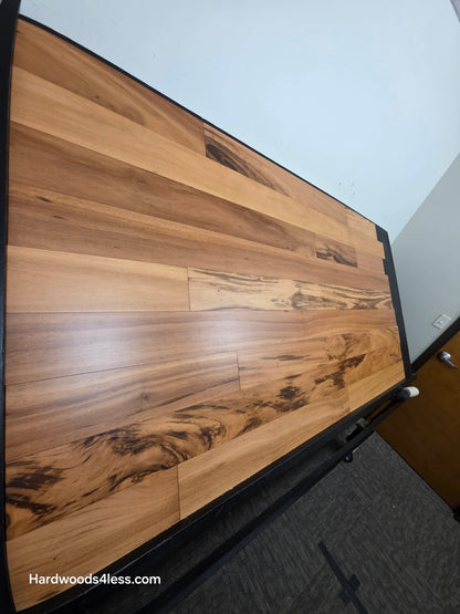 5" x 9/16" Engineered Brazilian Tigerwood Natural Hardwood Flooring. Shown on a black shooting table. Shot from steep left.
