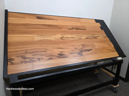 5" x 9/16" Engineered Brazilian Tigerwood Natural Hardwood Flooring. Shown on a black shooting table. Shot from wide left.