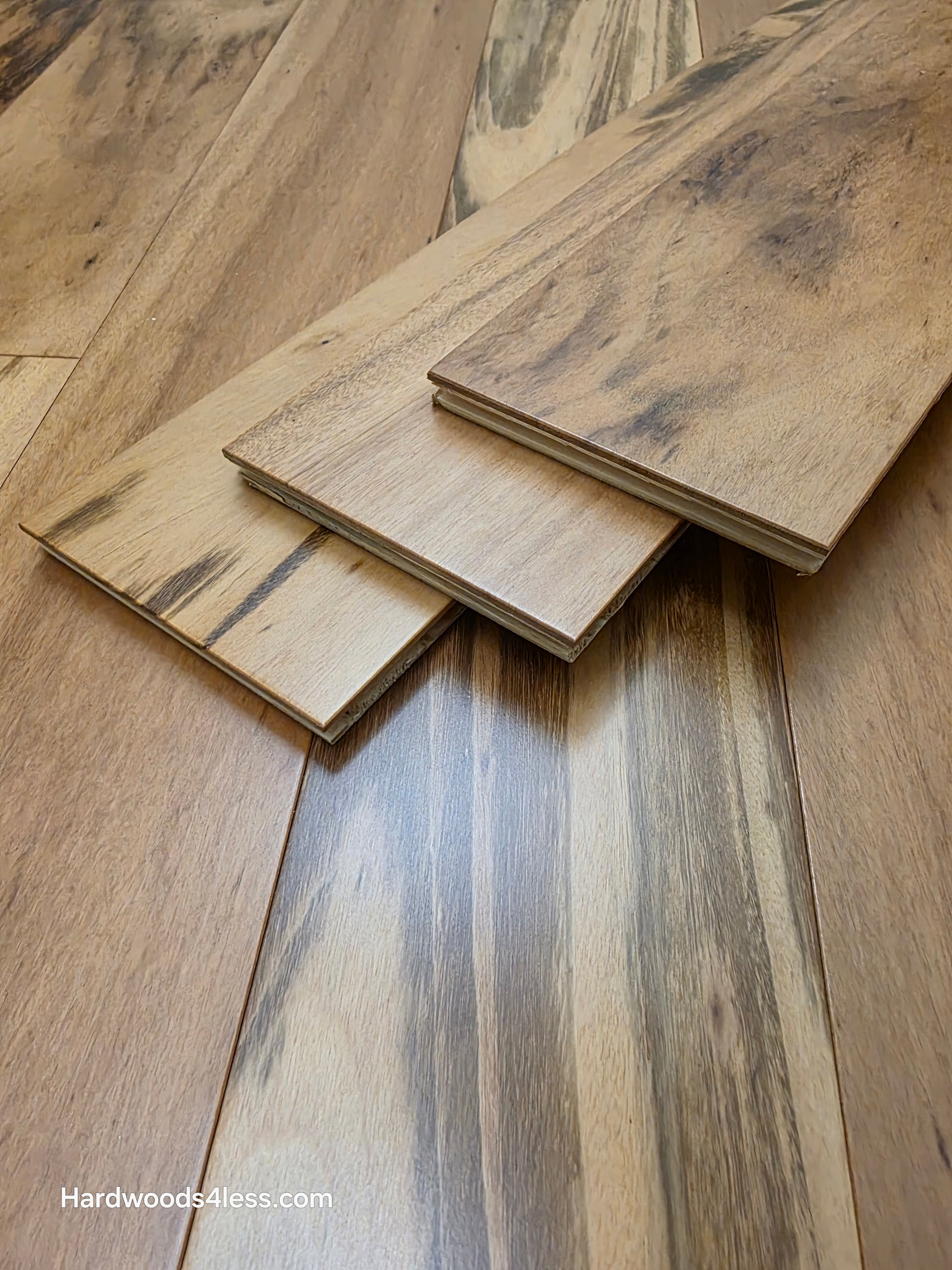5" x 9/16" Engineered Brazilian Tigerwood Natural Hardwood Flooring. Shown as 3 tiles stacked on top of the floor. 
