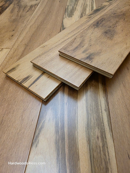 5" x 9/16" Engineered Brazilian Tigerwood Natural Hardwood Flooring. Shown as 3 tiles stacked on top of the floor. 