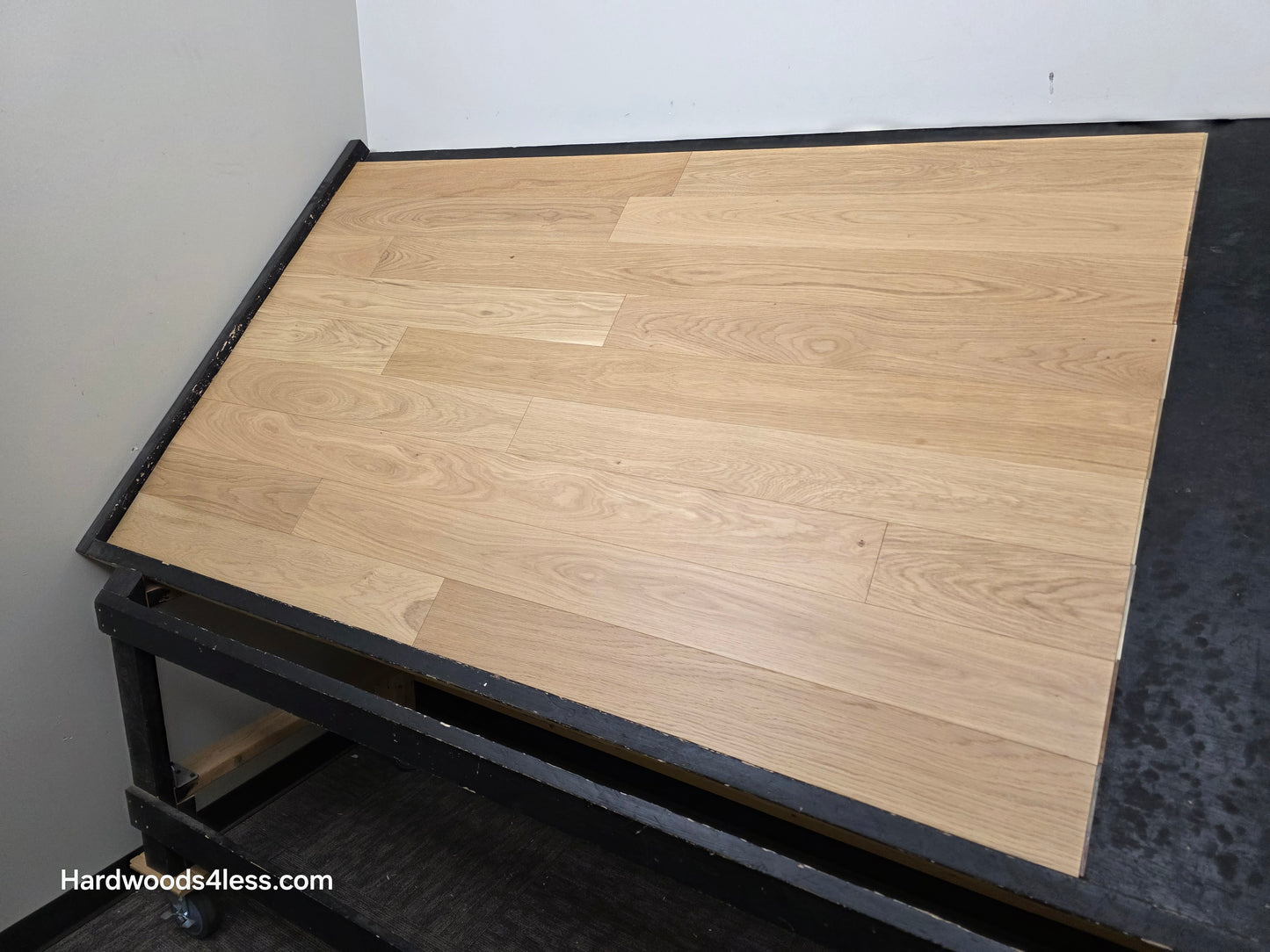 5" x 9/16" Engineered European Oak Natural Hardwood Flooring. shown on a black shooting table. shot from the right side. 