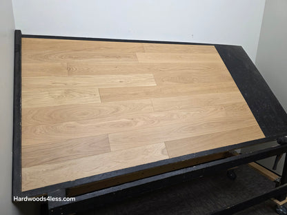 5" x 9/16" Engineered European Oak Natural Hardwood Flooring. Shown on a black shooting table shot from the left side.