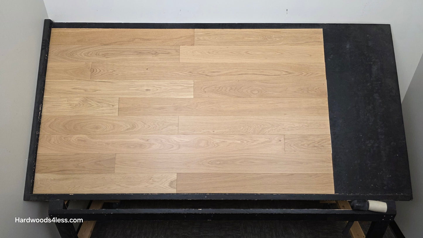 5" x 9/16" Engineered European Oak Natural Hardwood Flooring. Shown on a black shooting table. shot from center.