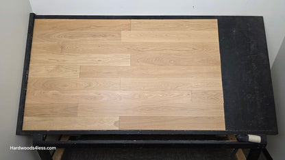 5" x 9/16" Engineered European Oak Natural Hardwood Flooring. Shown on a black shooting table. shot from center.