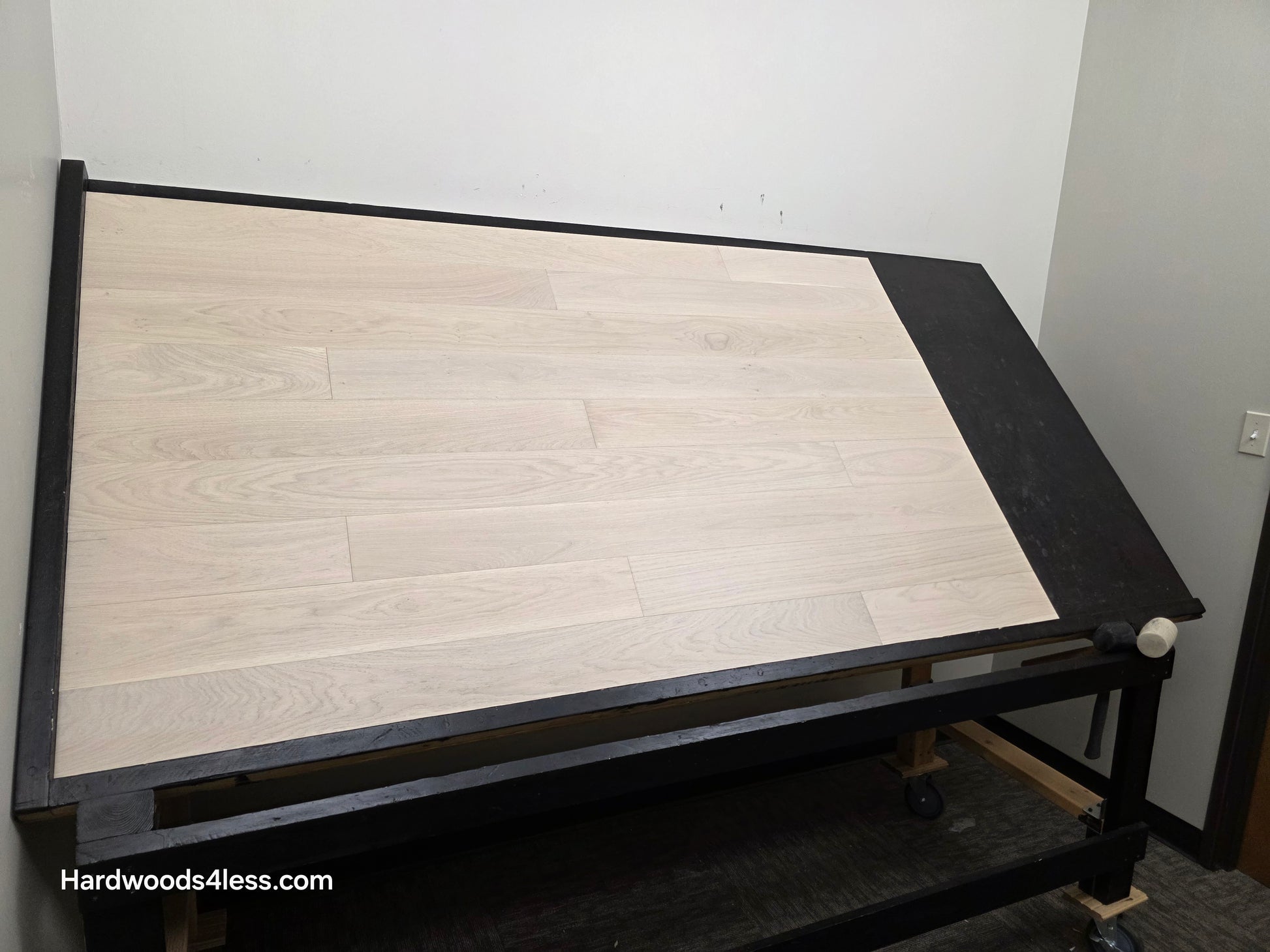 5" x 9/16" Engineered European Oak Vail Hardwood Flooring. Shown on a black shooting table. Shot from wide left. 
