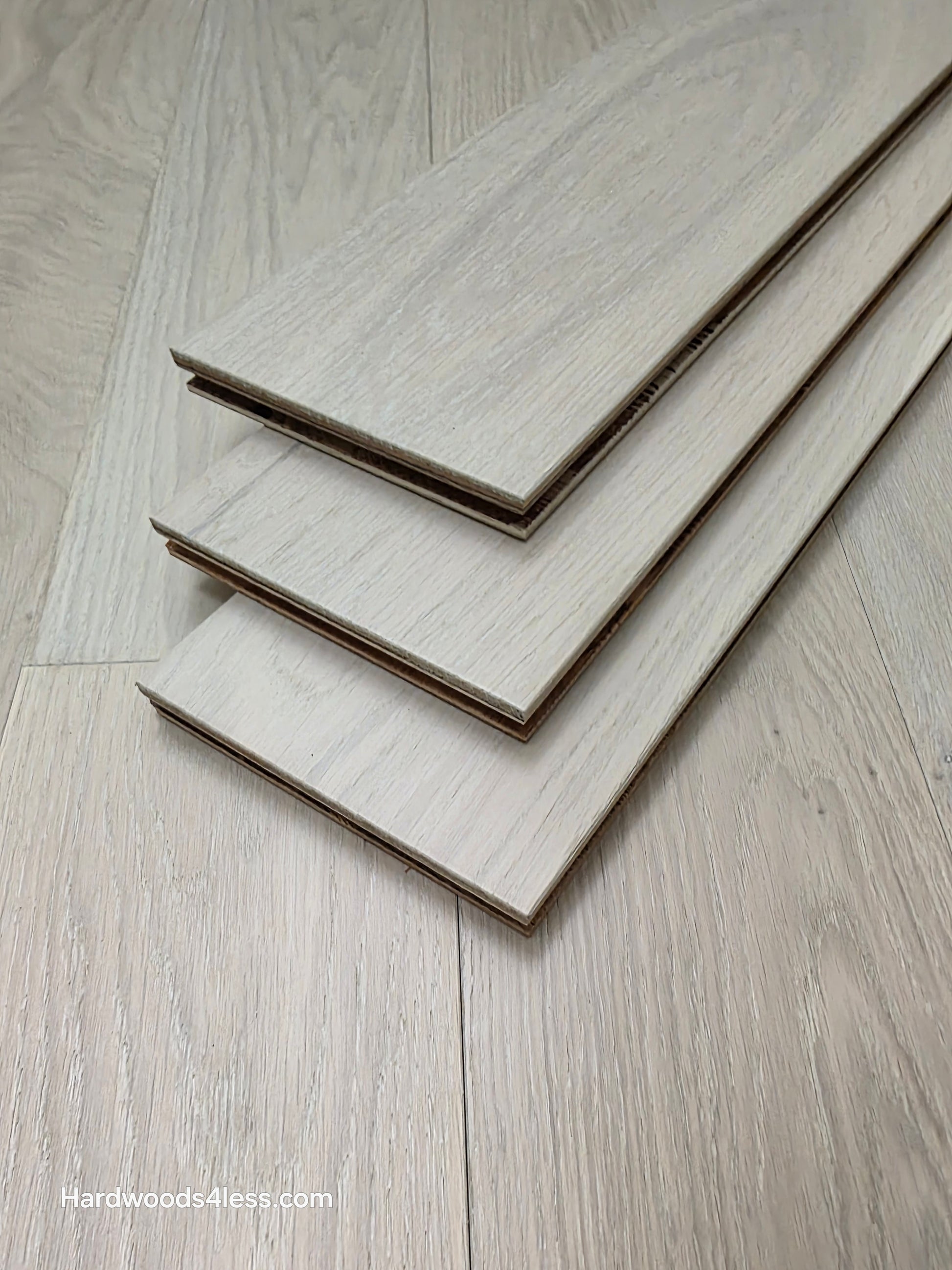 5" x 9/16" Engineered European Oak Vail Hardwood Flooring. Shown as 3 tiles stacked on the floor. 