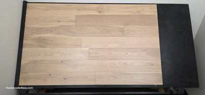 6 1/2" x 1/2" Engineered European White Oak Mojito Hardwood Flooring. Shown on a black shooting table. Shot from center.