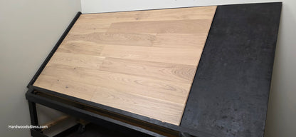 6 1/2" x 1/2" Engineered European White Oak Mojito Hardwood Flooring. Shown on a black shooting table. Shot from wide right.
