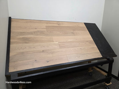 6 1/2" x 1/2" Engineered European White Oak Mojito Hardwood Flooring. Shown on a black shooting table. Shot from wide left.