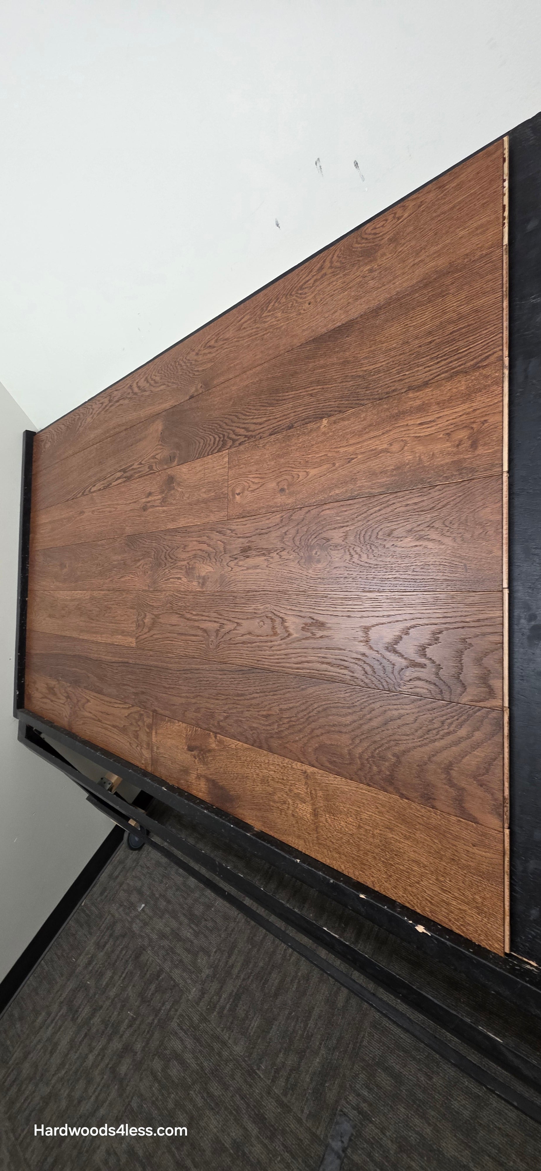 6 1/2" x 1/2" Engineered European White Oak Old Fashioned Hardwood Flooring. Shown on a black shooting table. Shot from steep right.
