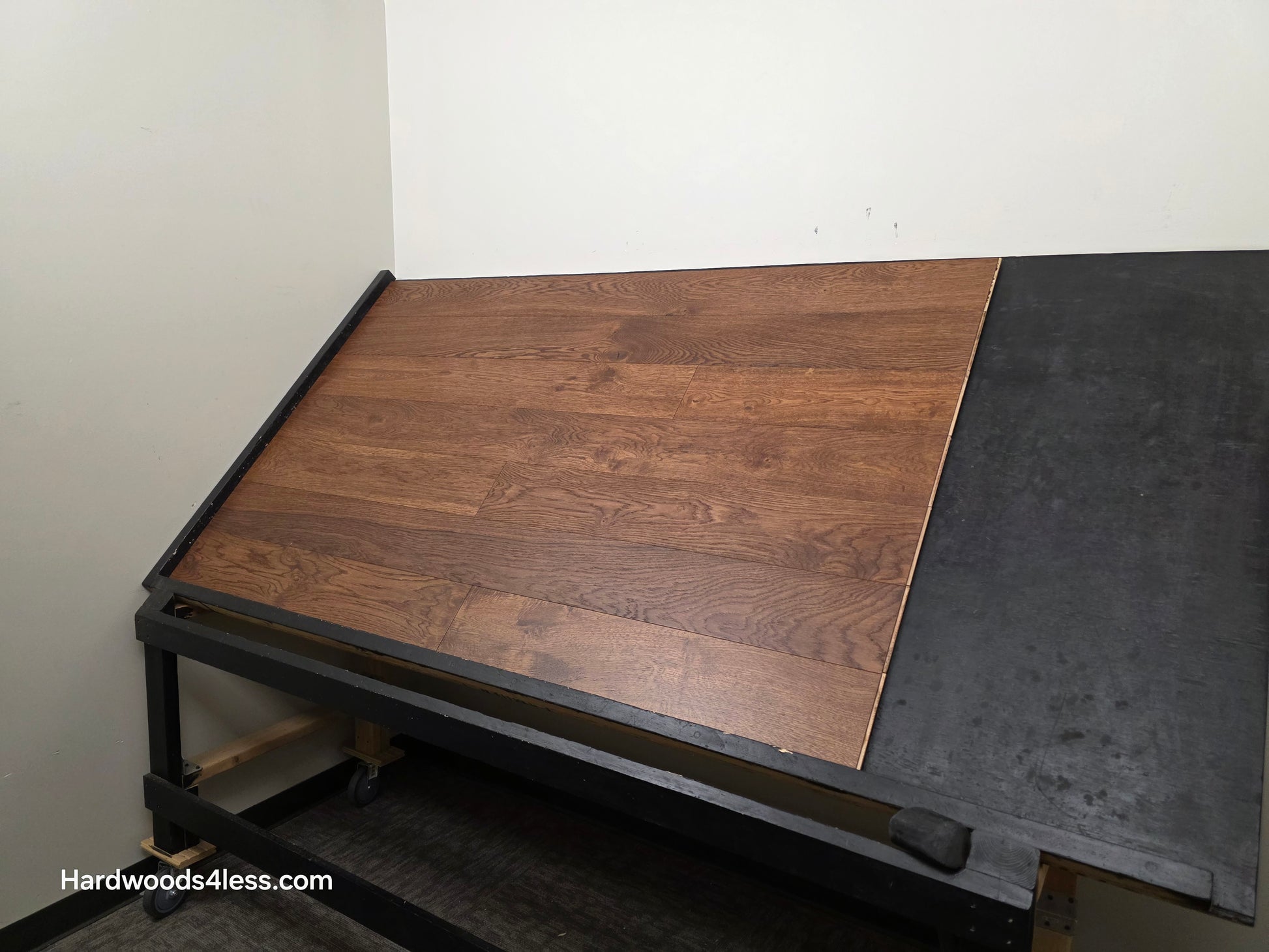 6 1/2" x 1/2" Engineered European White Oak Old Fashioned Hardwood Flooring. Shown on a black shooting table. Shot from wide right.