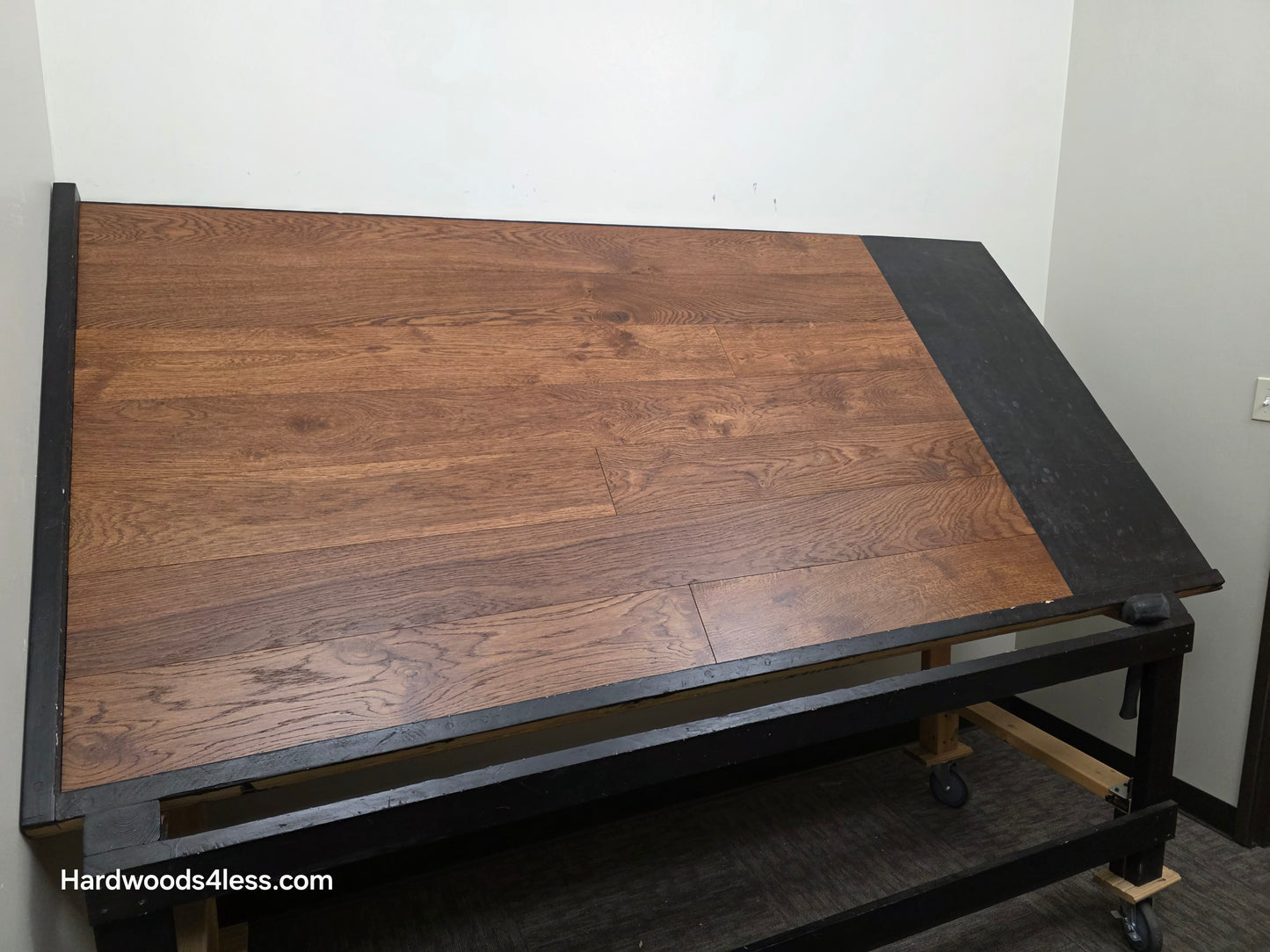 6 1/2" x 1/2" Engineered European White Oak Old Fashioned Hardwood Flooring. Shown on a black shooting table. Shot from wide left. 