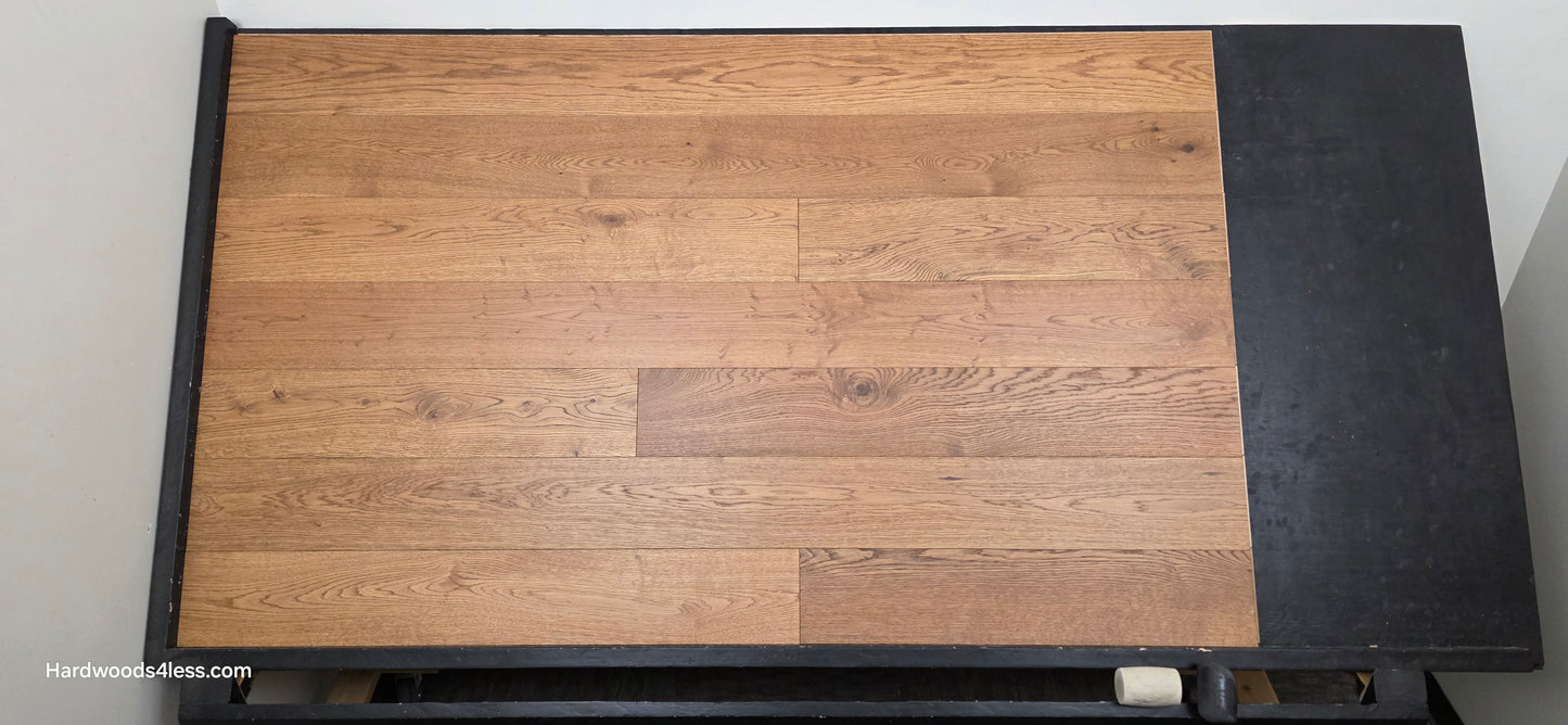 6 1/2" x 1/2" Engineered European White Oak Tequila Sunrise Hardwood Flooring. Shown on a black shooting table. Shot from center.