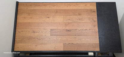 6 1/2" x 1/2" Engineered European White Oak Tequila Sunrise Hardwood Flooring. Shown on a black shooting table. Shot from center.