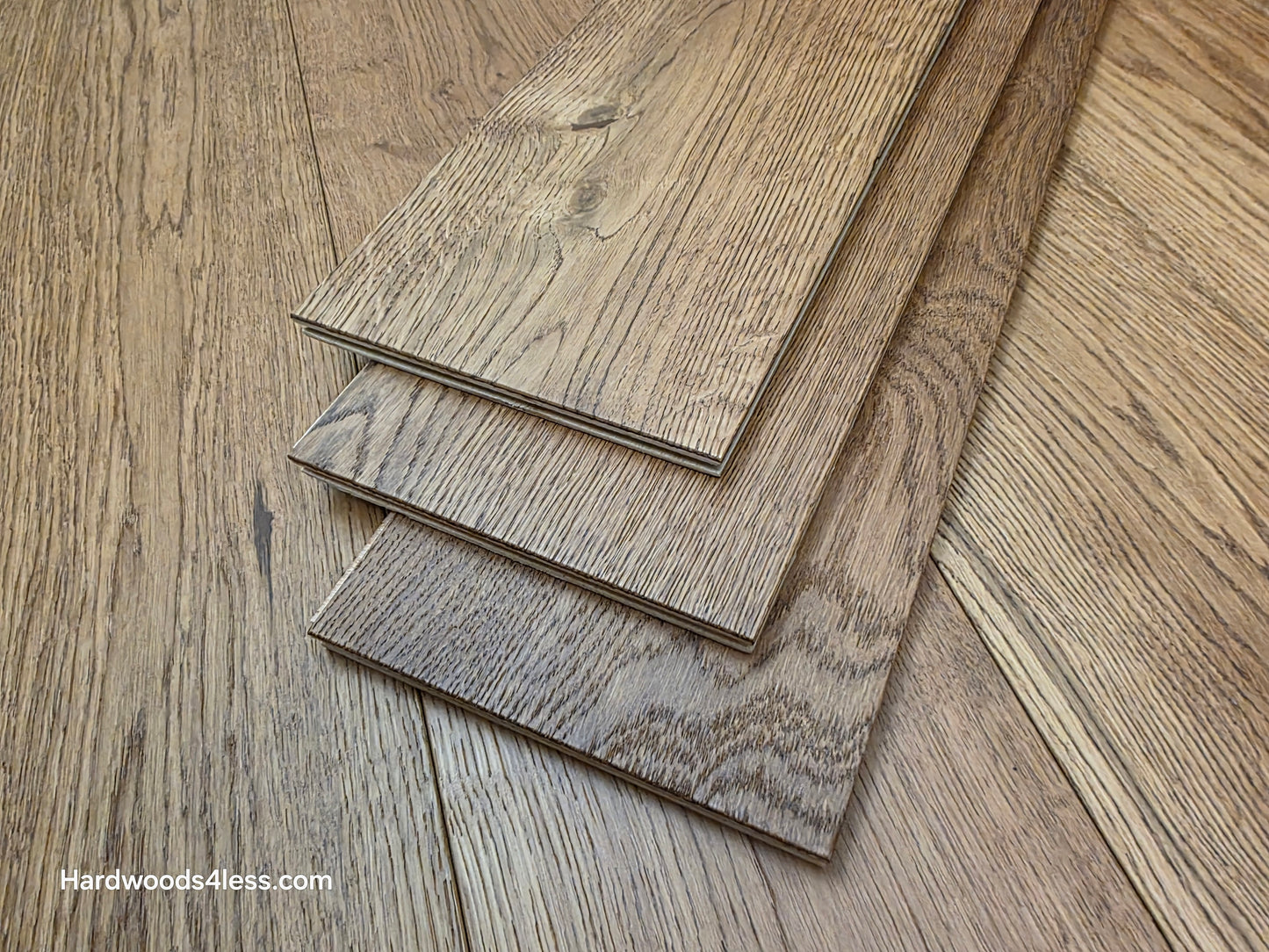 6 1/2" x 1/2" Engineered European White Oak Tequila Sunrise Hardwood Flooring. Shown as 3 tiles stacked atop the floor. 