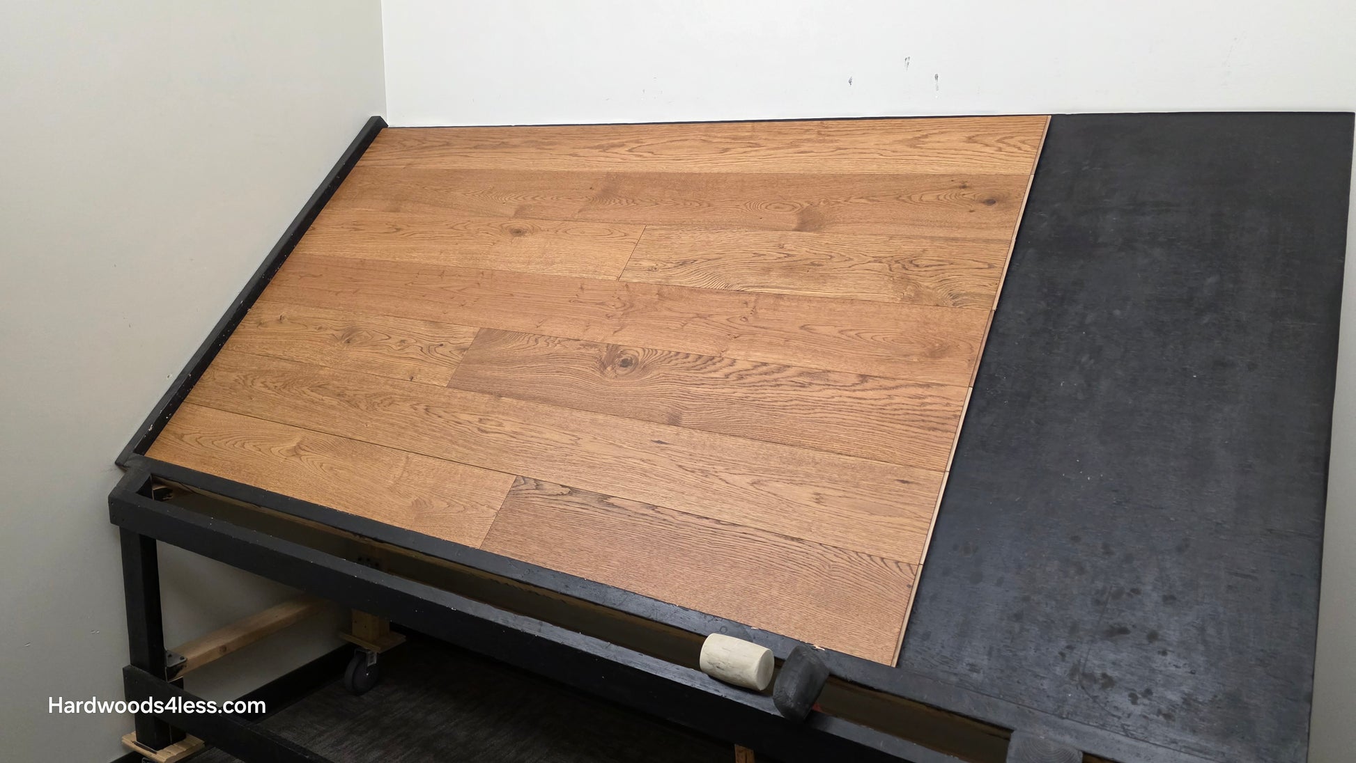 6 1/2" x 1/2" Engineered European White Oak Tequila Sunrise Hardwood Flooring. Shown on a black shooting table. Shot from wide right.