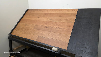 6 1/2" x 1/2" Engineered European White Oak Tequila Sunrise Hardwood Flooring. Shown on a black shooting table. Shot from wide right.