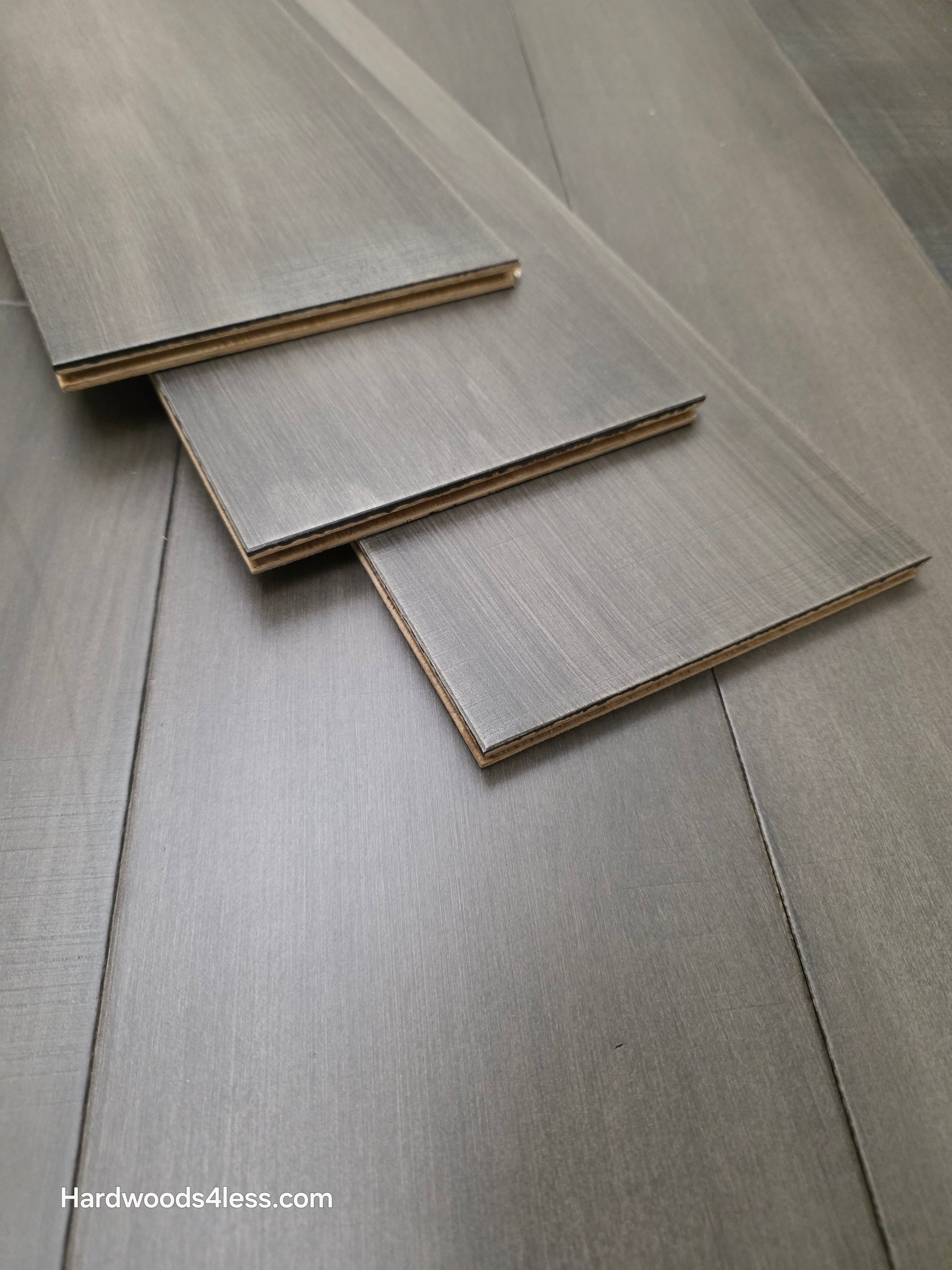 6 1/2" x 1/2" Engineered Maple Autumn Ash Hardwood Flooring shown with 3 boards stacked atop the flooring