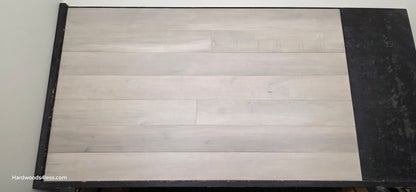 6 1/2" x 1/2" Engineered Maple Misty Moonlight Hardwood Flooring shown on a black shooting table.